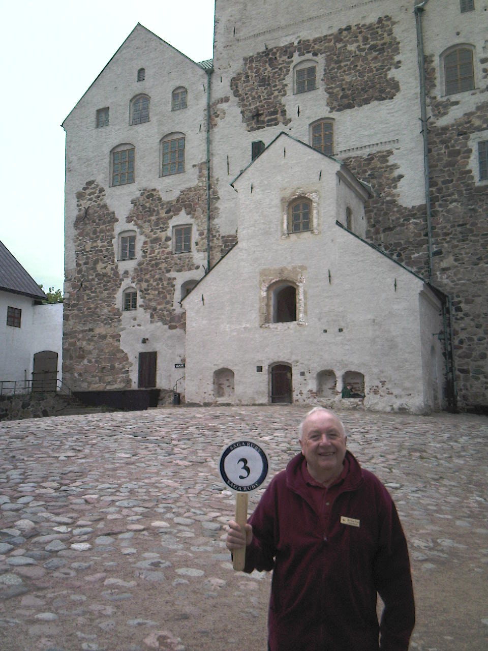 George in his ruby red tour escort's uniform at Turku castle